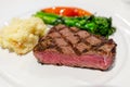 Delicious medium rare sirloin beef steak cut with mashed potato and vegetables Royalty Free Stock Photo