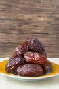 Delicious medjool dates ( kurma ) or sweet dried dates on a plate