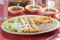 Delicious Mexican taco rolls with lettuce, sauce, rice and salsas Royalty Free Stock Photo