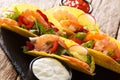 Delicious Mexican tacos with shrimps and vegetables close-up served with sauces. horizontal Royalty Free Stock Photo