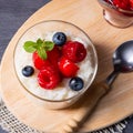 Delicious milk rice with different berries and red fruit jelly