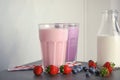 Delicious milk shakes and ingredients on table