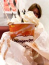 Delicious milkshake with female in background - Haagen-Dazs