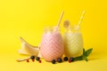 Delicious milkshakes on yellow background Sweet drink Royalty Free Stock Photo