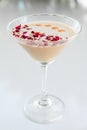 Milky rose cocktail with red petals