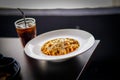 Tasty minced beef spaghetti decorated with parsley on white plate and coke stock photo