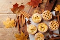 Delicious mini apple pies on rustic wooden table. Autumn pastry desserts.