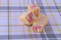 Delicious mini Battenberg cake, the traditional sweet afternoon tea snack. Pink and yellow sponge cake covered in jam wrapped in Royalty Free Stock Photo