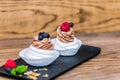 Delicious mini Pavlova meringue cake decorated with fresh blueberry and rasberry Royalty Free Stock Photo