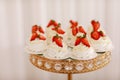 Delicious mini Pavlova meringue cakes with fresh strawberry on gold festive tray Royalty Free Stock Photo