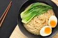 Delicious miso ramen noodles with egg in a bowl on a wood background.Top view Royalty Free Stock Photo