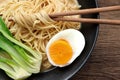 Delicious miso ramen noodles with egg in a bowl on a wood background.Top view Royalty Free Stock Photo