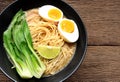 Delicious miso ramen noodles with egg in a bowl on a wood table.Top view Royalty Free Stock Photo