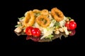 Delicious mixed salad caesar with crispy squids,  with reflection Royalty Free Stock Photo