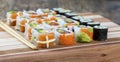 Delicious mixed sushi arranged on brown wooden surface Royalty Free Stock Photo