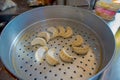 Delicious momo food over a metallic tray in the kitchen, type of South Asian dumpling native to Tibet, Nepal, Bhutan and