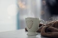 Delicious morning coffee and knitted sweater on table indoors