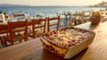 Delicious Moussaka served at a seaside restaurant at sunset Royalty Free Stock Photo