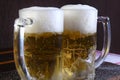 Delicious mug of super cold and refreshing draft beer on the table in the blurred background Royalty Free Stock Photo