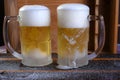 Delicious mug of super cold and refreshing draft beer on the table in the blurred background Royalty Free Stock Photo