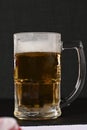 delicious mug of super cold and refreshing draft beer on the table in the blurred background Royalty Free Stock Photo