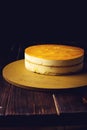 Delicious multi-layered fruit mango cake stands on circular base