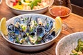 Delicious mussels in restaurant on a wooden table. Tasty seafood with beer in cafe or pub menu. Royalty Free Stock Photo