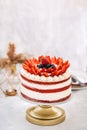 Delicious naked red velvet cake decorated with cream and fresh berries Royalty Free Stock Photo