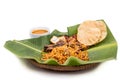 Delicious nasi briyani meal with mutton, dhal on banana leaf