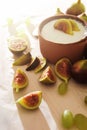 Delicious natural Greek yogurt in clay bowl with figs