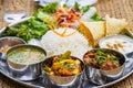 Delicious Nepali Food Dal Bhaat Tarkari. A plate of rice, vegetables, meat and salad