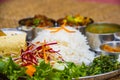 Delicious Nepali Food Dal Bhaat Tarkari. A plate of rice, vegetables, meat and salad