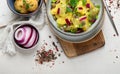 Delicious new potato salad with red onion, capers, greens in a bowl Royalty Free Stock Photo