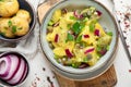 Delicious new potato salad with red onion, capers, greens in a bowl Royalty Free Stock Photo