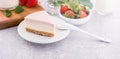 Delicious and nutritious handmade strawberry no bake frozen gradient colour fromage frais cheesecake slice with raw sarcocarp Royalty Free Stock Photo