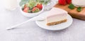 Delicious and nutritious handmade strawberry no bake frozen gradient colour fromage frais cheesecake slice with raw sarcocarp Royalty Free Stock Photo