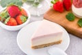 Delicious and nutritious handmade strawberry no bake frozen gradient colour fromage frais cheesecake slice with raw sarcocarp Royalty Free Stock Photo