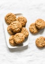 Delicious oatmeal and peanut butter gluten free cookies with walnuts on a light background, top view
