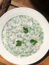 Delicious okroshka with kefir in a white plate