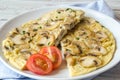 Delicious omelet with mushrooms and tomatoes