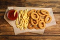 Delicious onion rings, fries and ketchup on table, top view Royalty Free Stock Photo