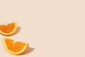 Delicious orange citrus fruit pieces on a light orange background