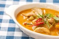 Delicious orange Thai panang curry in white bowl