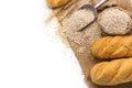 Delicious organic bread with wheat ears and wheat grains There is space to copy text. On a white table top in a rustic kitchen - Royalty Free Stock Photo