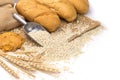 Delicious organic bread with wheat ears and wheat grains There is space to copy text. On a white table top in a rustic kitchen - Royalty Free Stock Photo