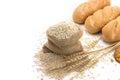 Delicious organic bread with wheat ears and wheat grains There is space to copy text. On a white table top in a rustic kitchen - Royalty Free Stock Photo