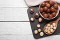 Delicious organic Macadamia nuts on white wooden table, top view. Space for text Royalty Free Stock Photo