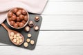 Delicious organic Macadamia nuts on white wooden table, top view. Space for text Royalty Free Stock Photo