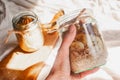 Delicious overnight oats with banana and walnuts minimalistic sunny shot walnuts banana sustainable concept hand holding a jar