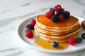 Delicious pancakes with berries, honey or maple syrup. Homemade pancakes and sweet syrup on white plate isolated. Royalty Free Stock Photo